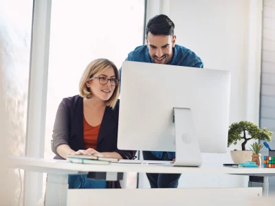 temp putting technology work shot young man woman using computer together modern office